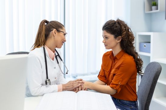 Female doc assisting female patient